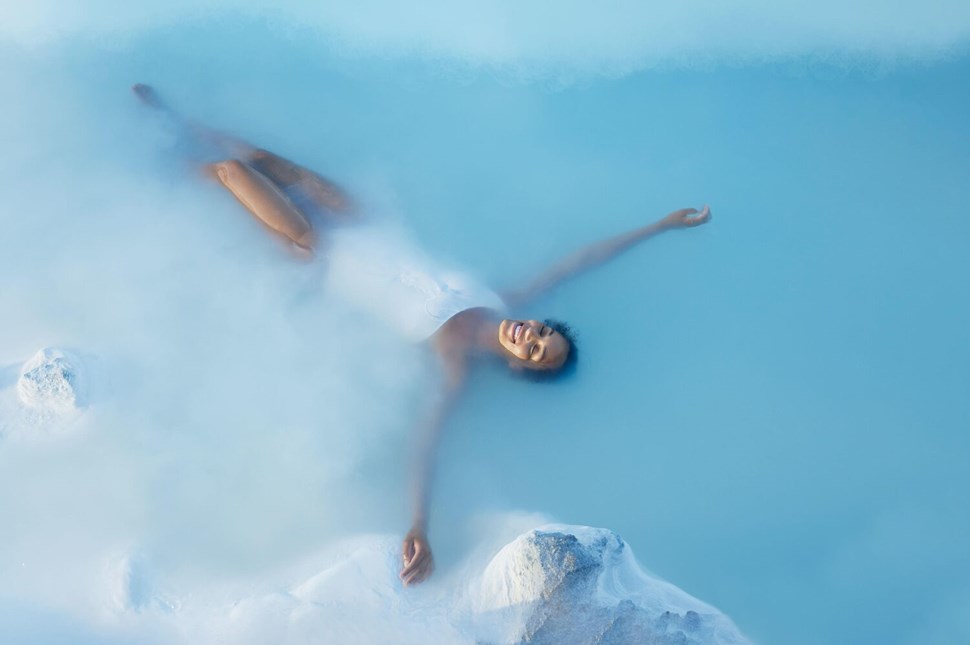 Woman Laying In Blue Lagoon Spa In Iceland