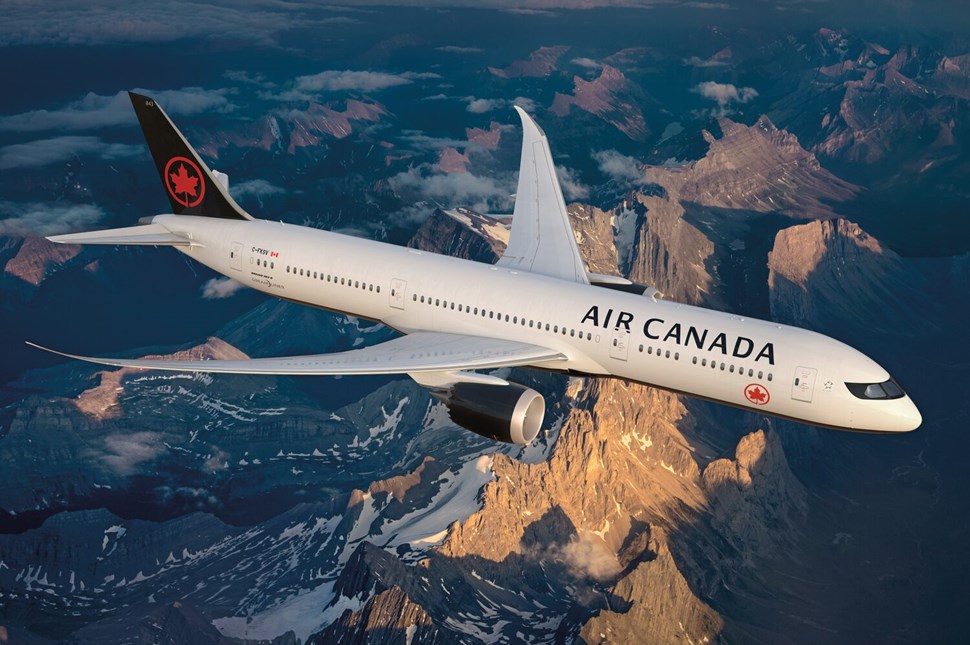 Air Canada’s plane flying over the mountain range