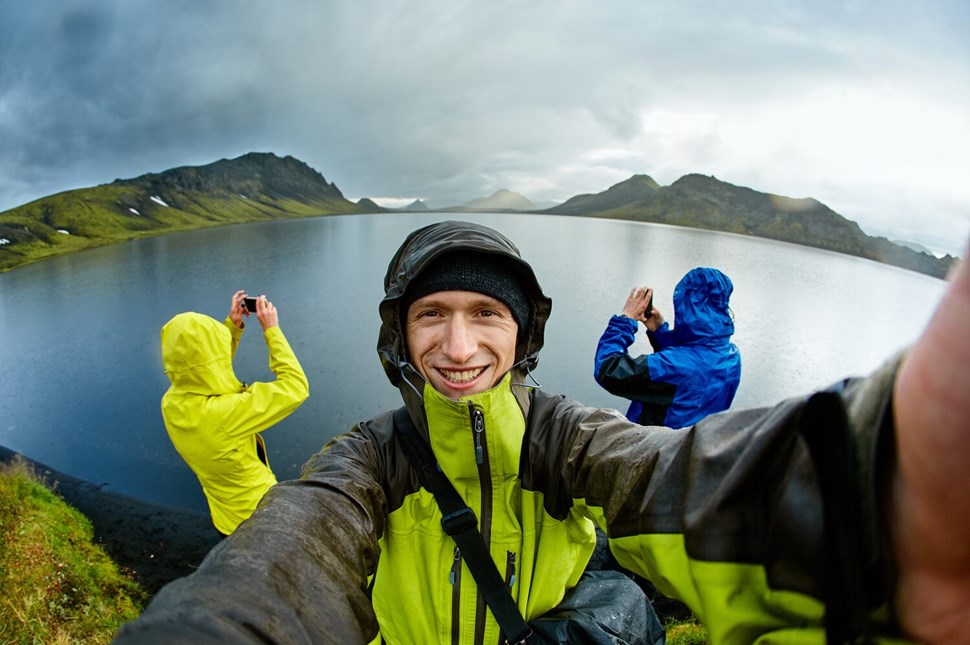 Hikers taking pictures near the lake in Iceland