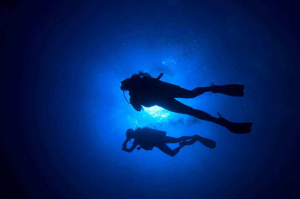 Two Divers in Blue Water in Silfra