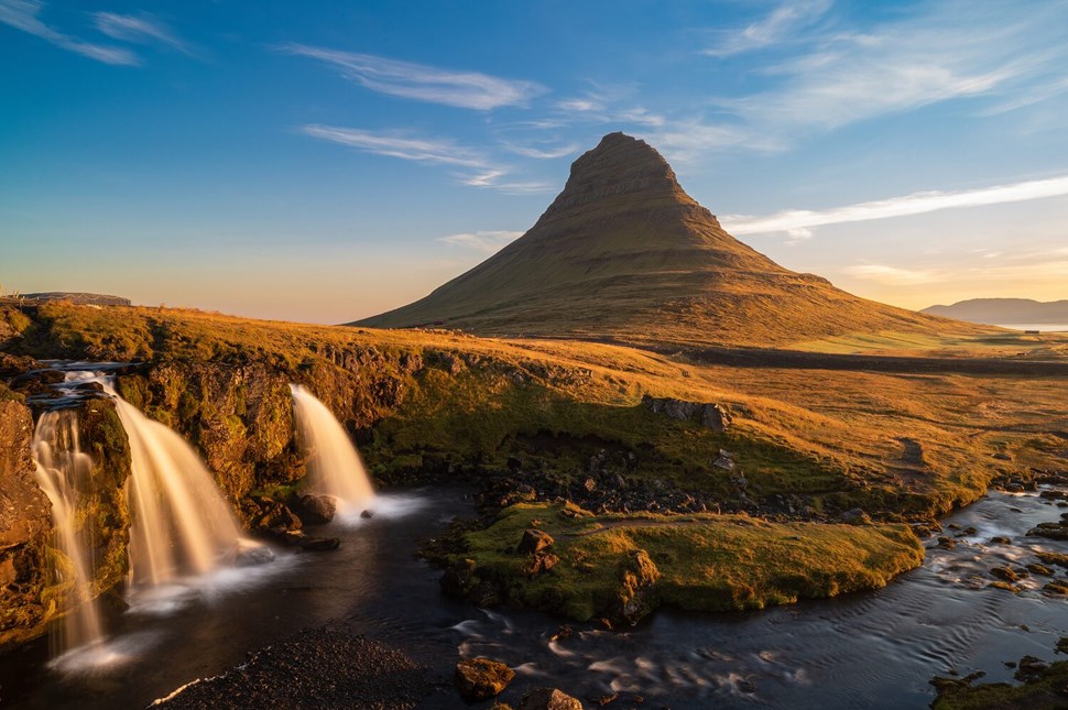 Waterfalls with a backdrop of a majestic Kirkjufell mountain during golden hour