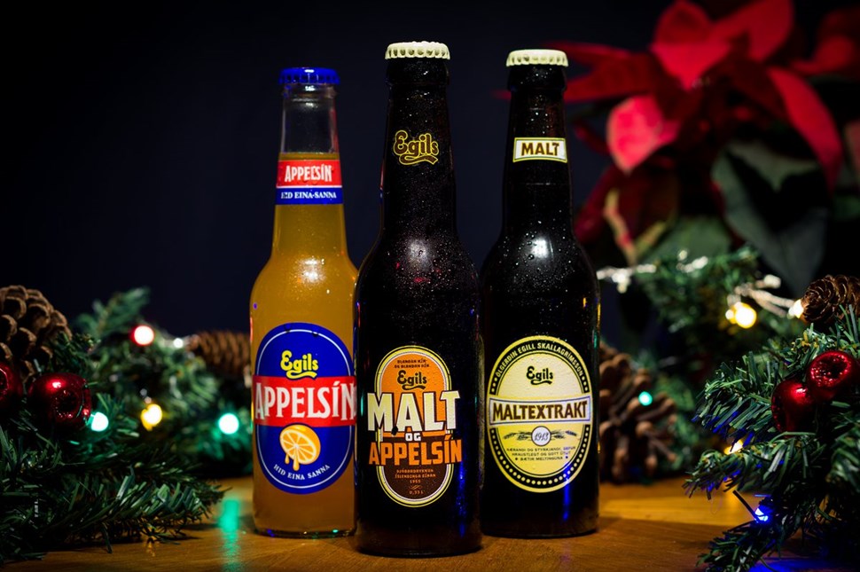 Traditional Icelandic Christmas beverages, Appelsín and Malt, displayed among festive decorations.