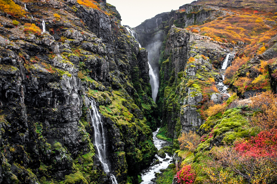 Glymur Waterfall in West Iceland showing water cascading through moss-covered rocky terrain