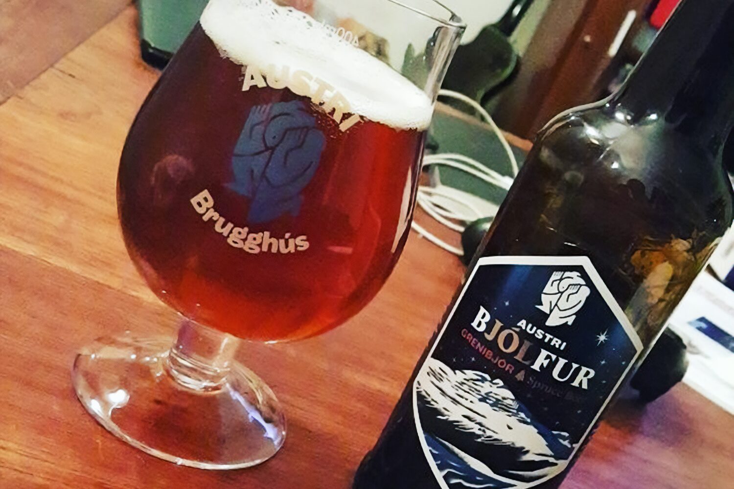 Bjolfur Grenibjor Christmas beer in a glass and in a bottle