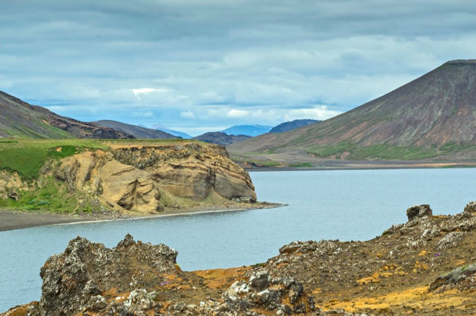 Lake Kleifarvatn with rocky outcrops and volcanic surroundings.