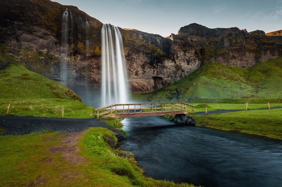Seljalandsfoss Waterfall in Iceland with a bridge over the river downstream
