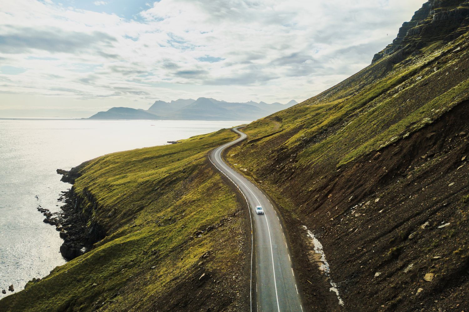 Car driving on a beautiful scenic road in Iceland.