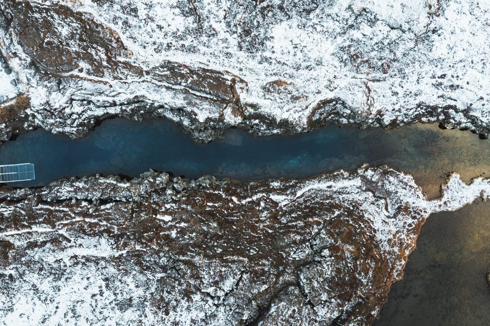 Fissure in Iceland view from above of snowy landscape.