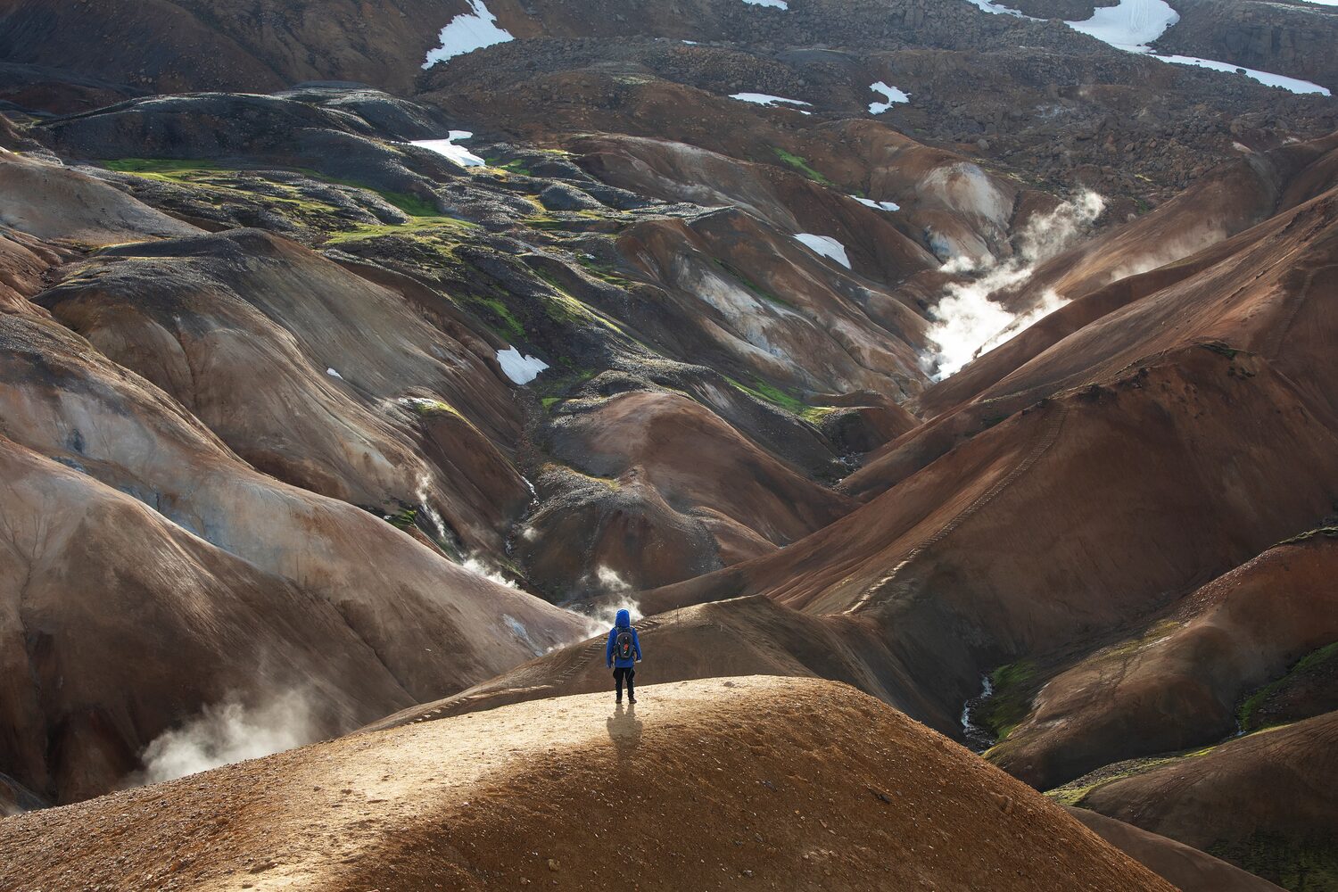 Traveler standing in between mountains