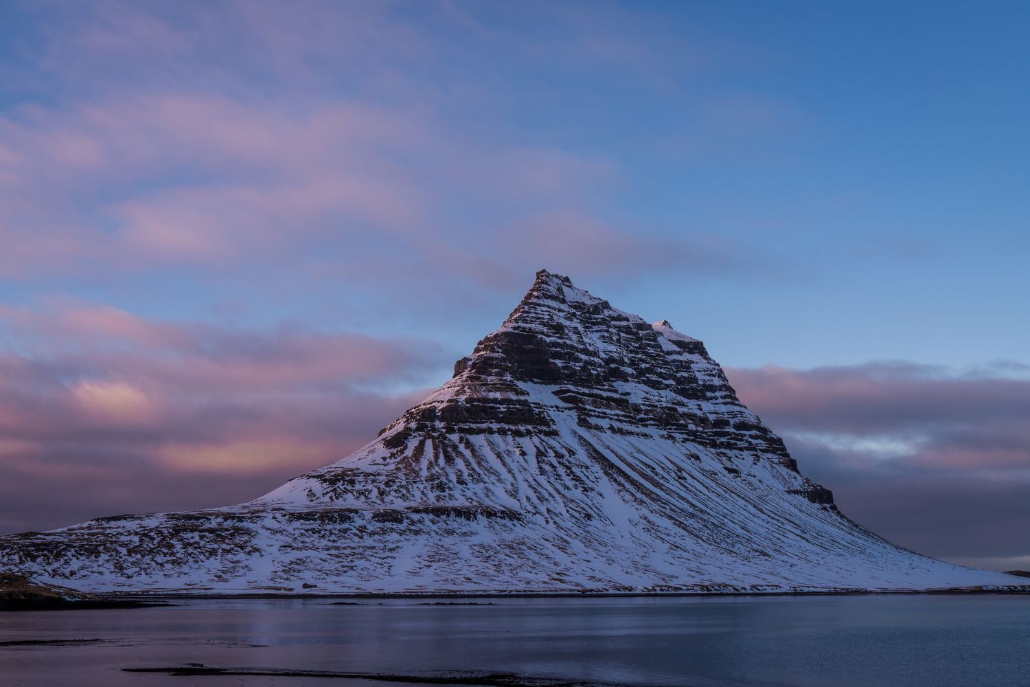 Snow-covered Kirkjufell Mountain at sunset