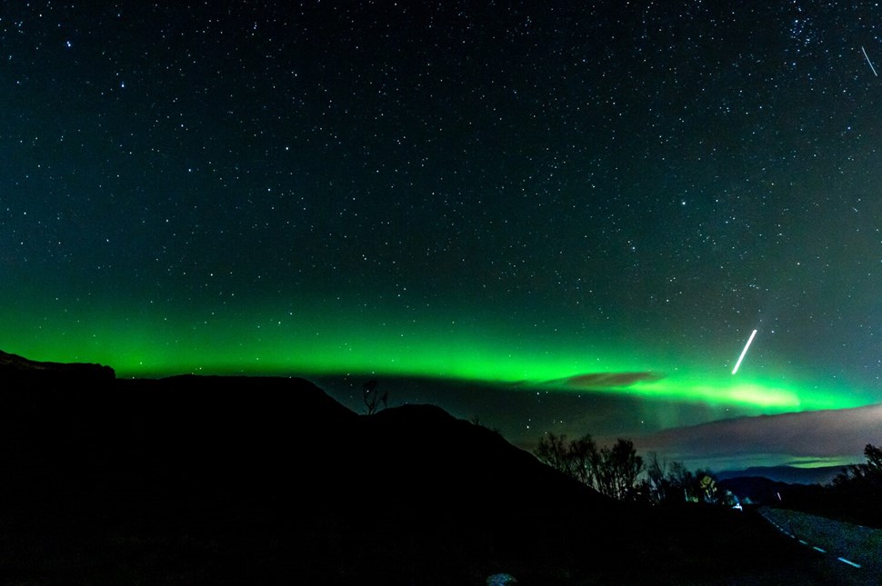 Night Sky Illuminated by Northern Lights In The Mountains