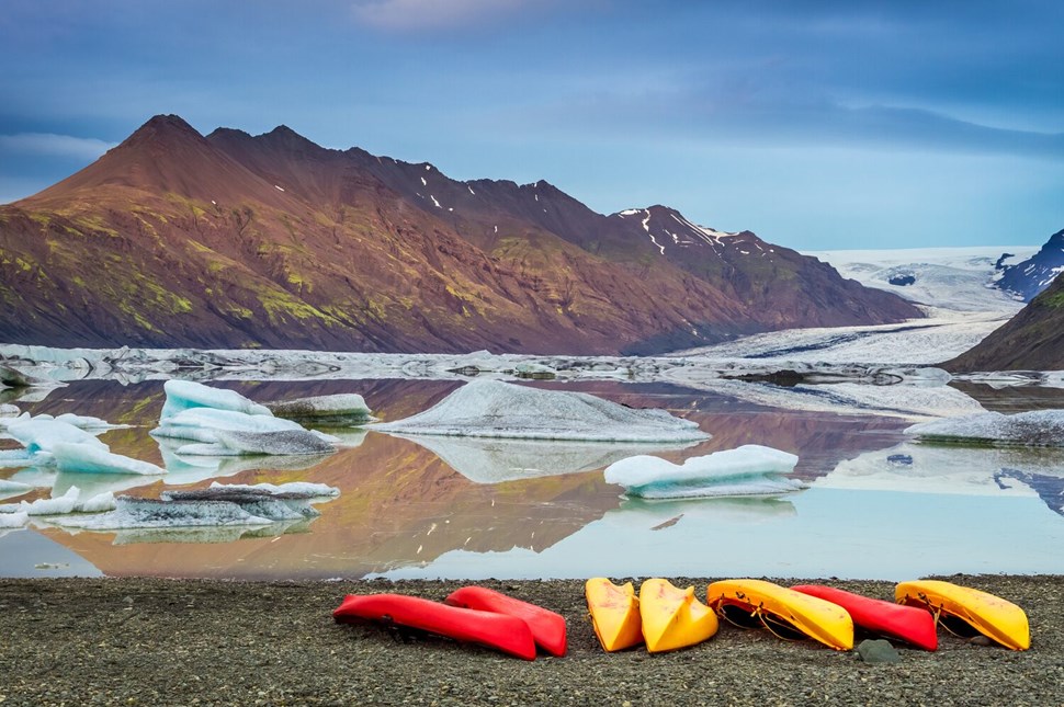 Kayaks At Glacial Lake In The Cold Mountains, Iceland