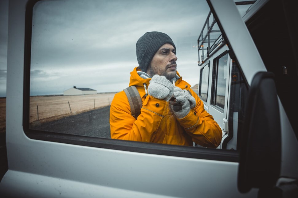Driver standing by the car in Iceland