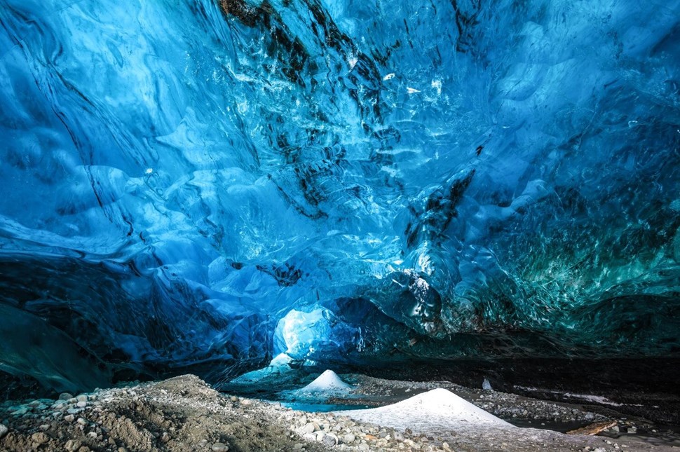 Glacial cave in Iceland with blue-colored ice
