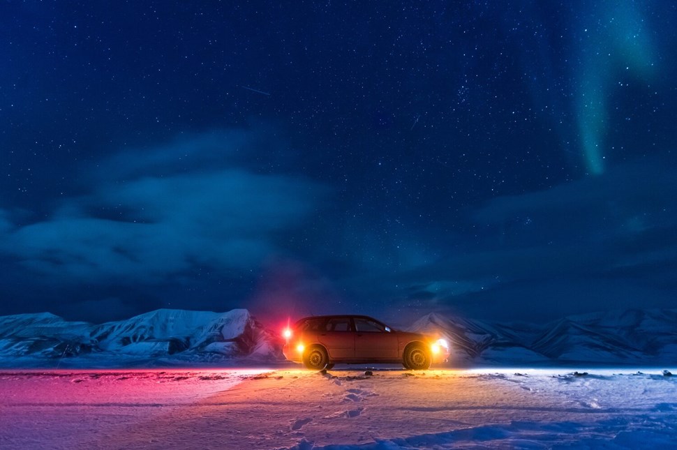A car in the middle of a wintery night