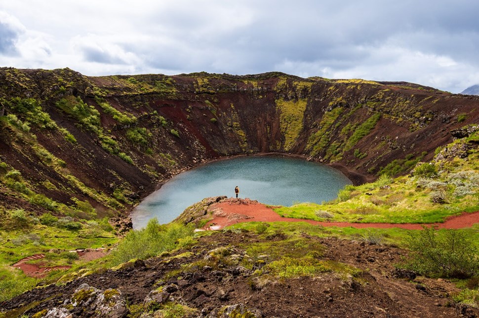 Woman stands near Kerid crater lake