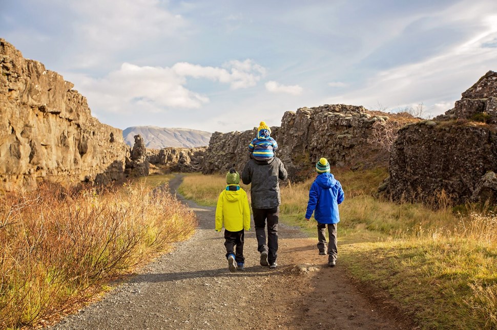 Father with children walking in Thingvellir