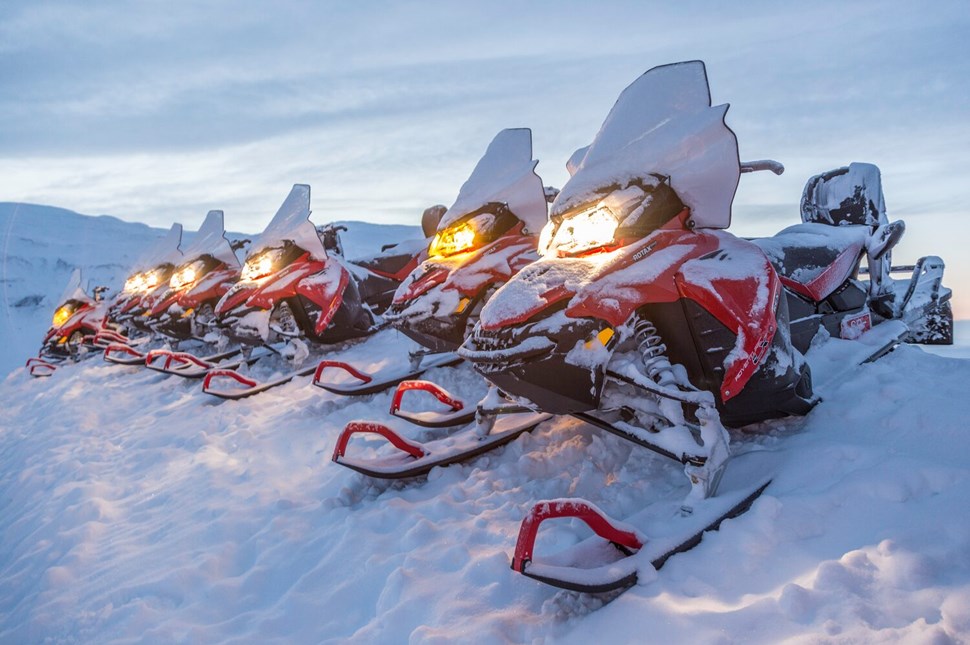 Snowmobiles covered in snow