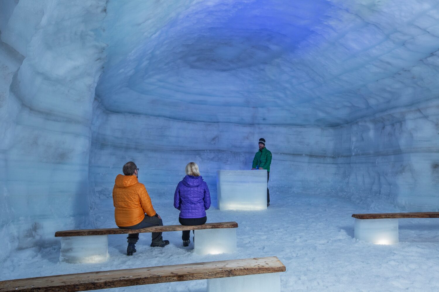 Three people in chapel made from ice