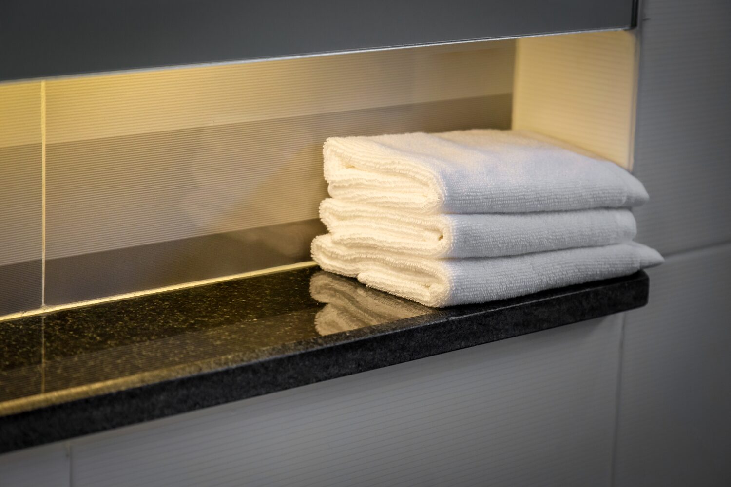 White folded towels on shelf