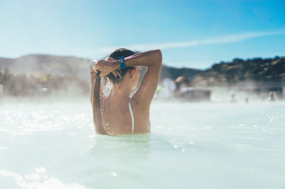 Young woman in milky waters of geothermal pool