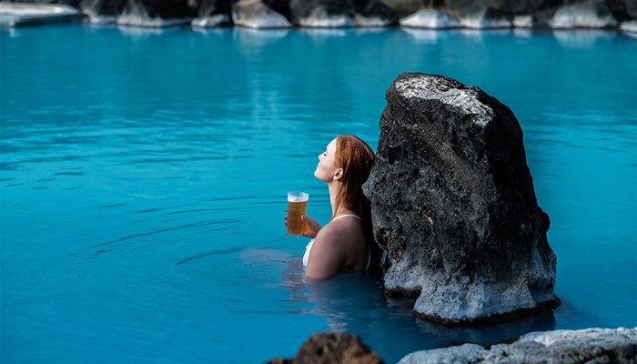 Woman drinking beer in Myvatn Nature Baths