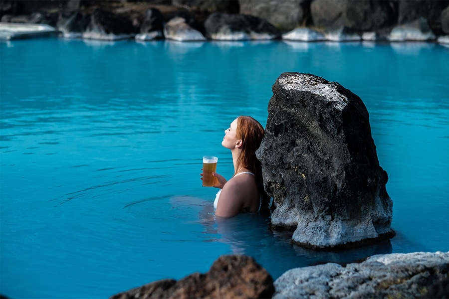 Woman drinking beer in Myvatn Nature Baths