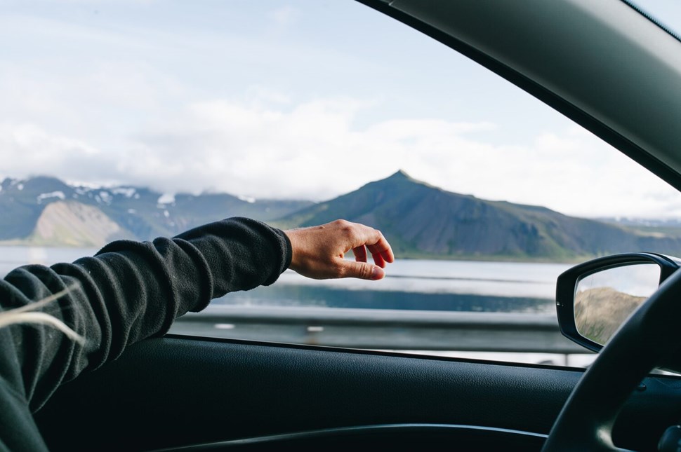 Driving in Iceland with open window and arm out 