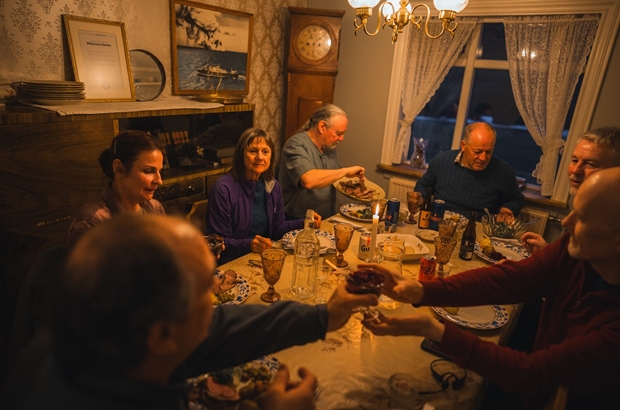 Group of people eating dinner in farmhouse hotel
