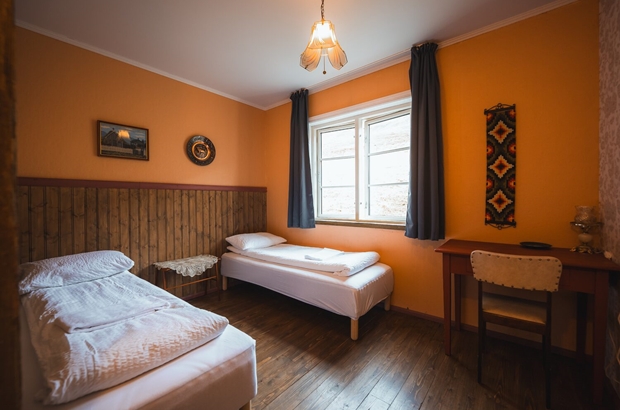 Farmhouse bedroom with orange walls in Iceland