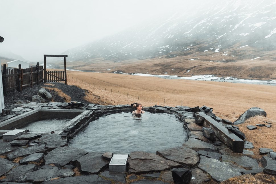 Woman bathing in natural hot spring tub