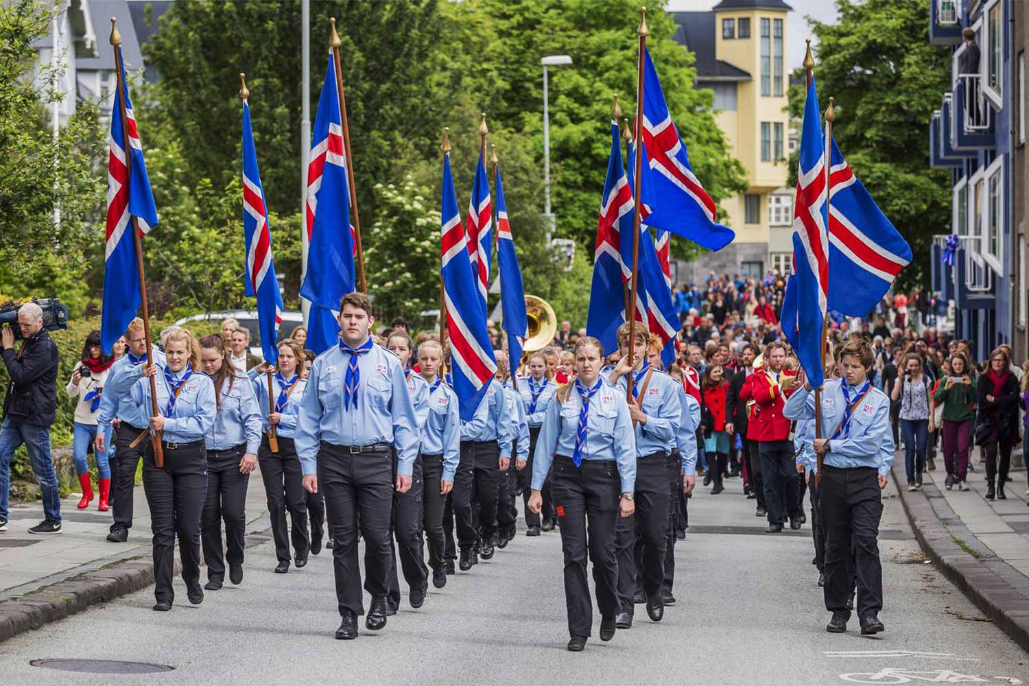 Uniformed crowd with flags marching