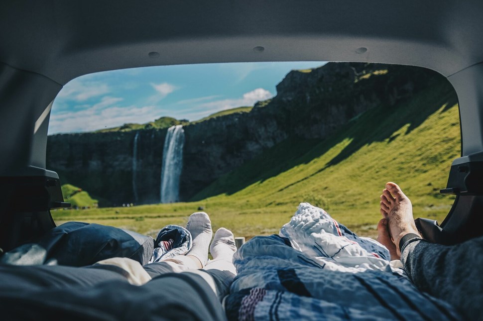 Couple's POV over Icelandic nature from camper van