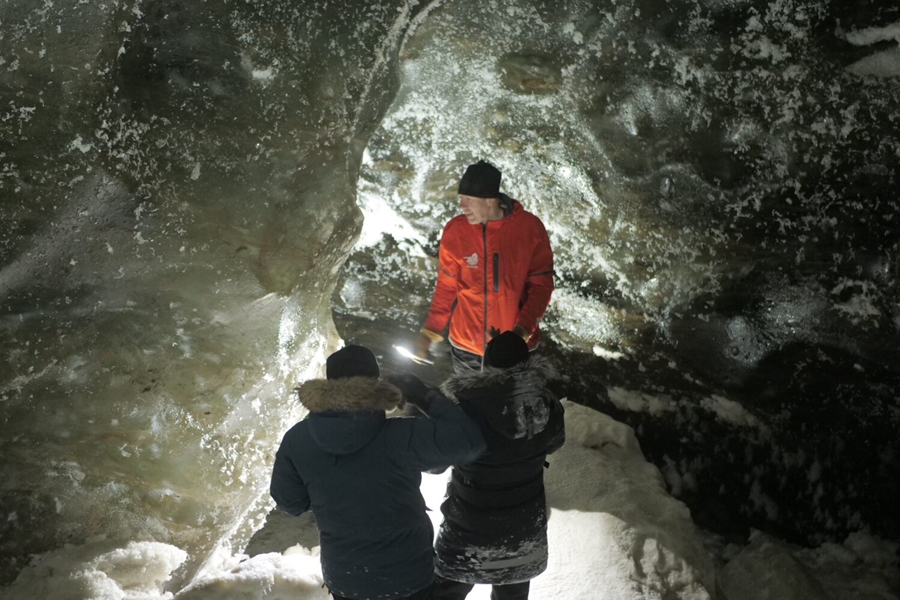 People exploring an ice cave