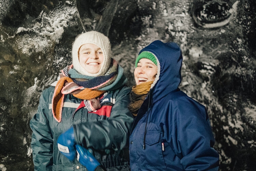 Two women smiling in cave