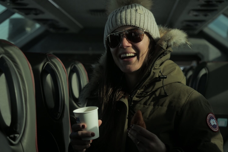 Happy woman drinks coffee in the truck