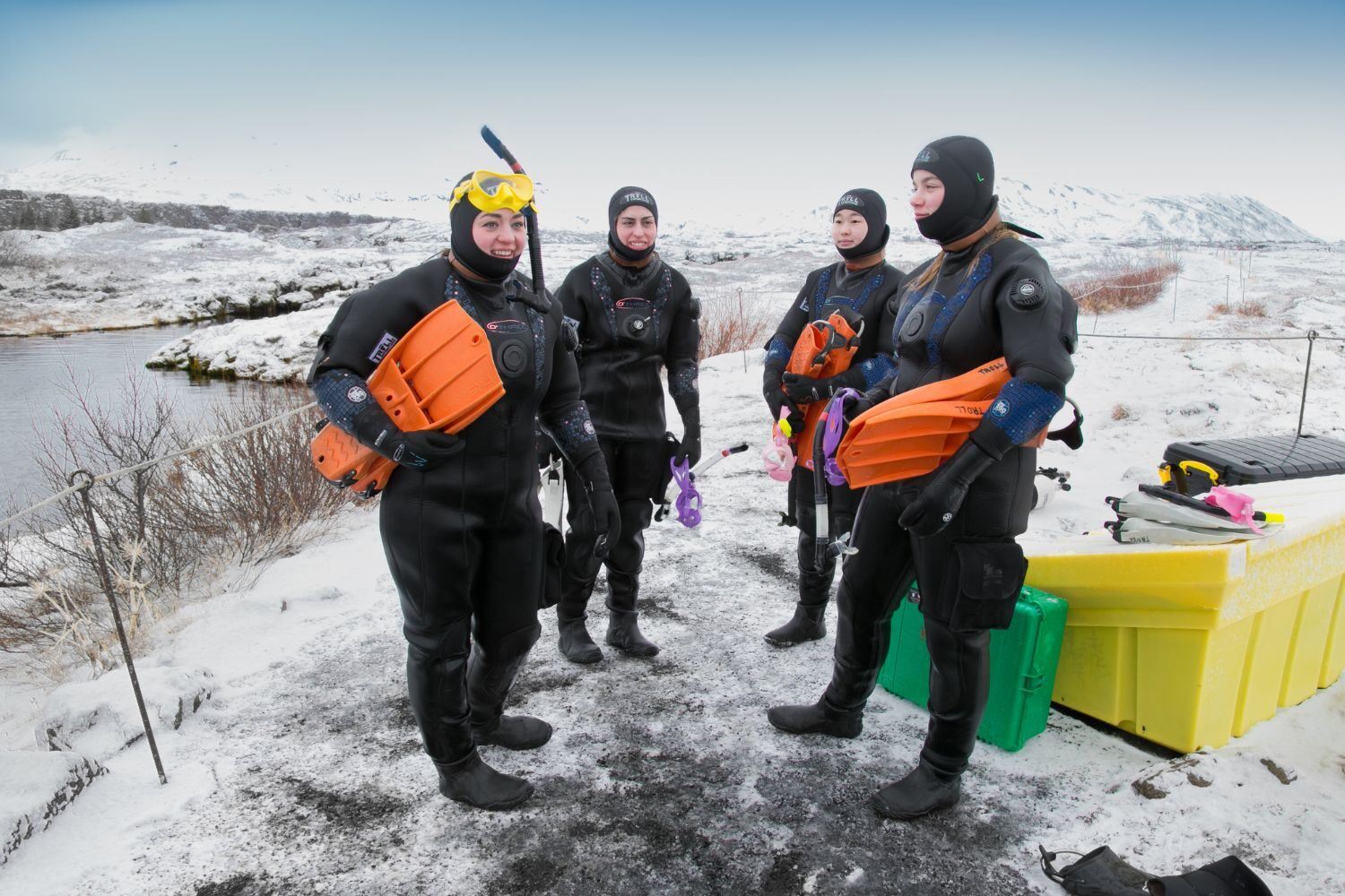 Group of people ready to go snorkeling at Silfra Rift in snowy landscape