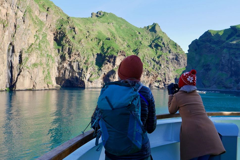 Boat tour Heimaklettur Women watching birds with binoculars on ferry boat to Heimaey, Westman Islands, Iceland. High quality photo