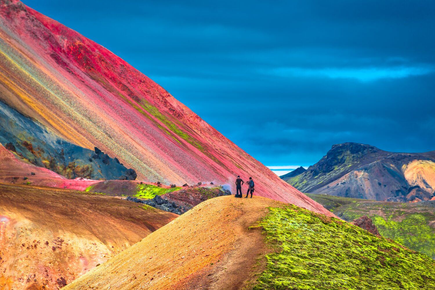 Beautiful multi colored volcanic mountains in Landmannalaugar in Iceland with deep blue sky