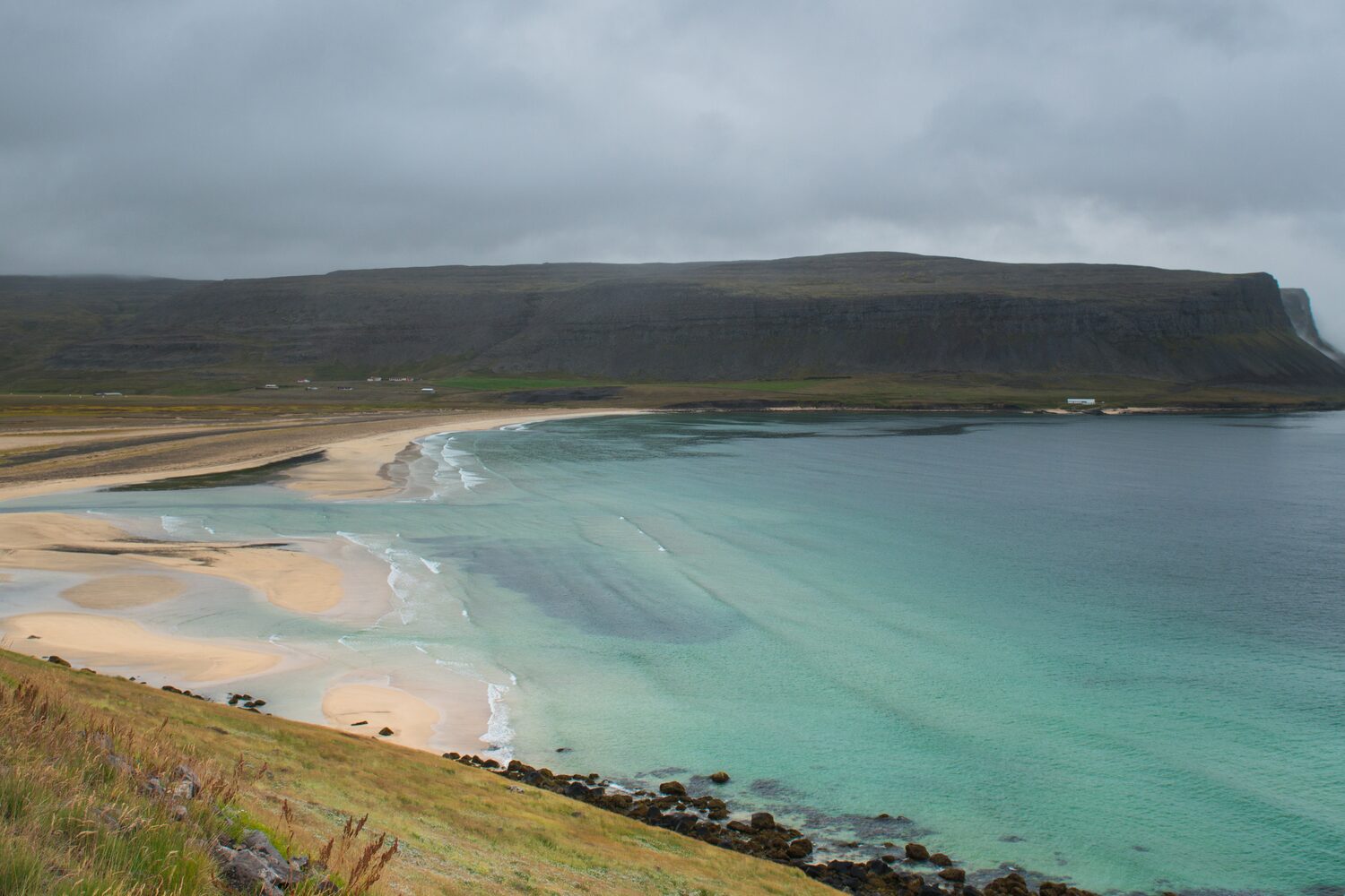 Ariel view of clear seawater and coast at Breidavik in Westfjords.