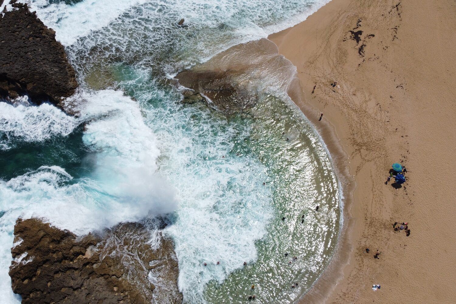 Ariel view of waves cashing at shore of beach in Iceland.