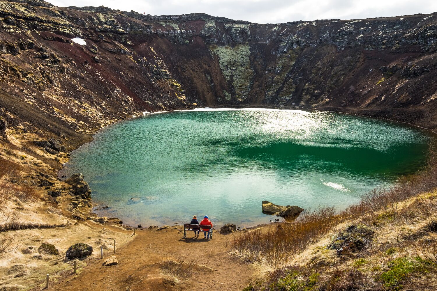 Sun shining reflection on Kerid crater lake in Icleand.