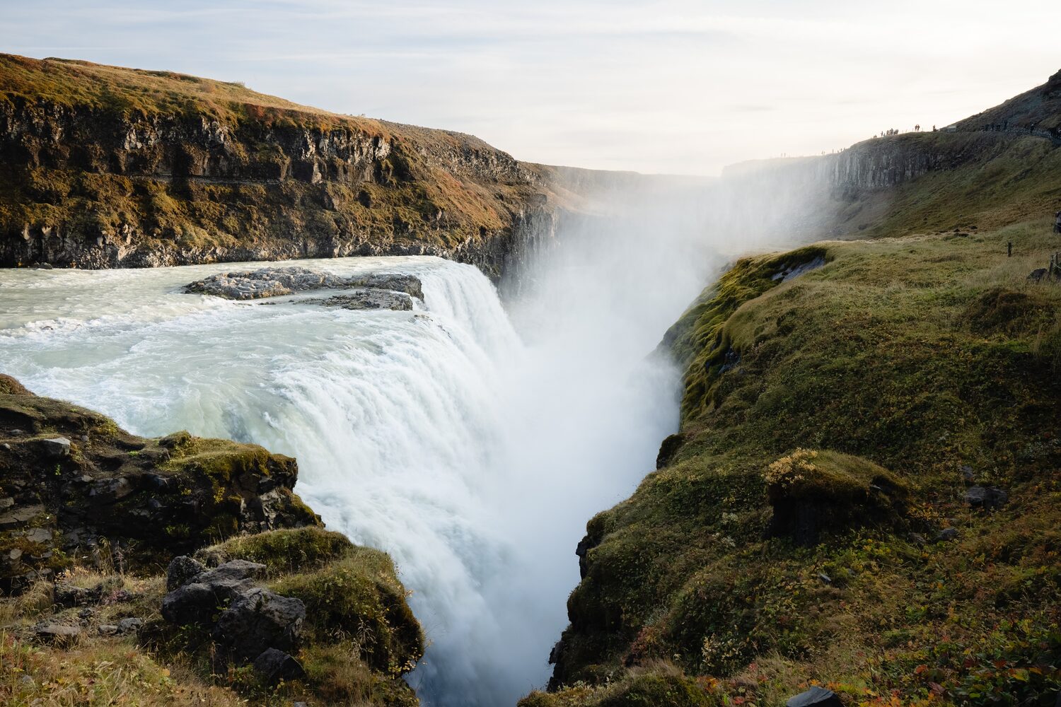 Gullfoss waterfall, the golden waterfall in the golden circle in iceland surrounded by cliffs.