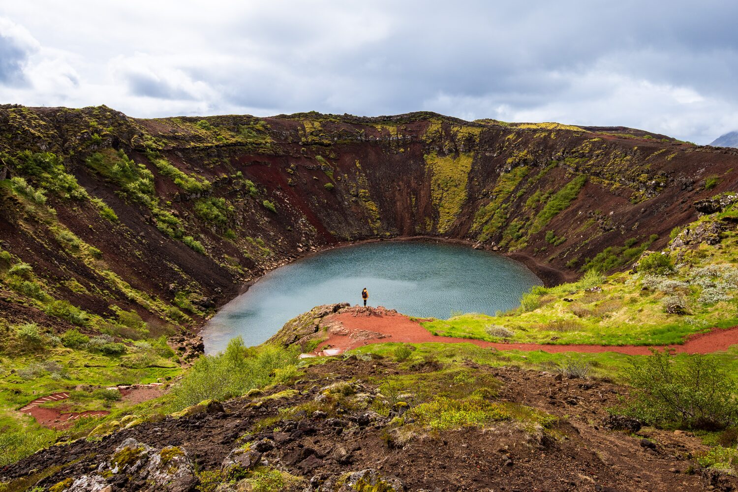 Kerid Volanic lake in summer with tourist.