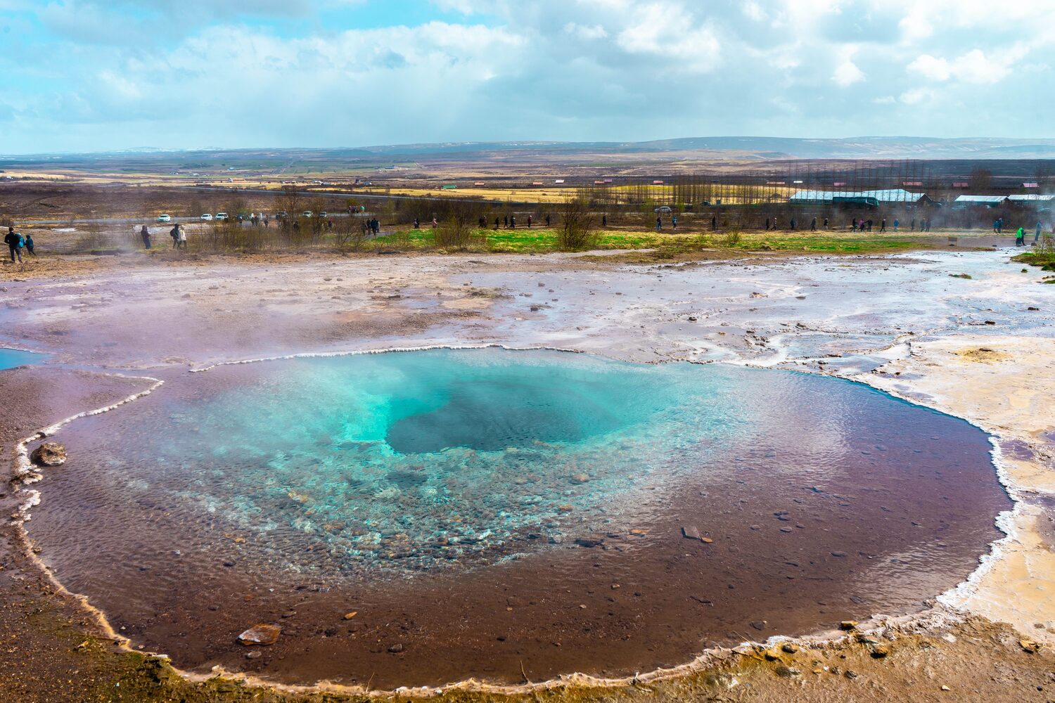 Bright blue geysir in the golden circle on sunny day.