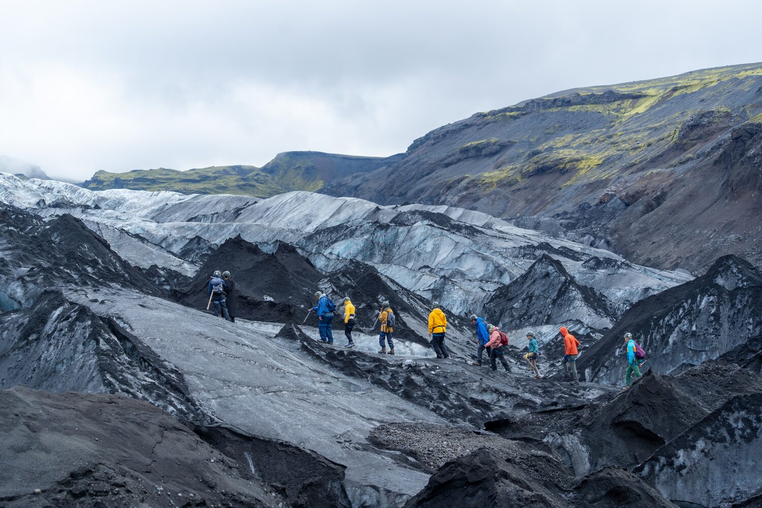 Guided hike on glacier covered in volcanic ash