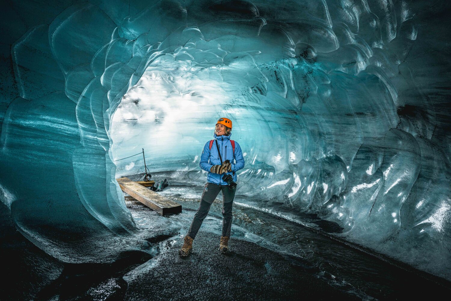 Excited woman in big natural ice cave