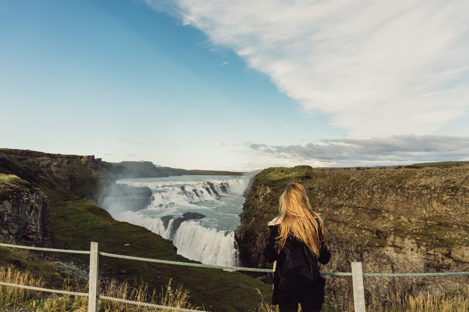 Woman looking at Gullfoss waterfall in Iceland