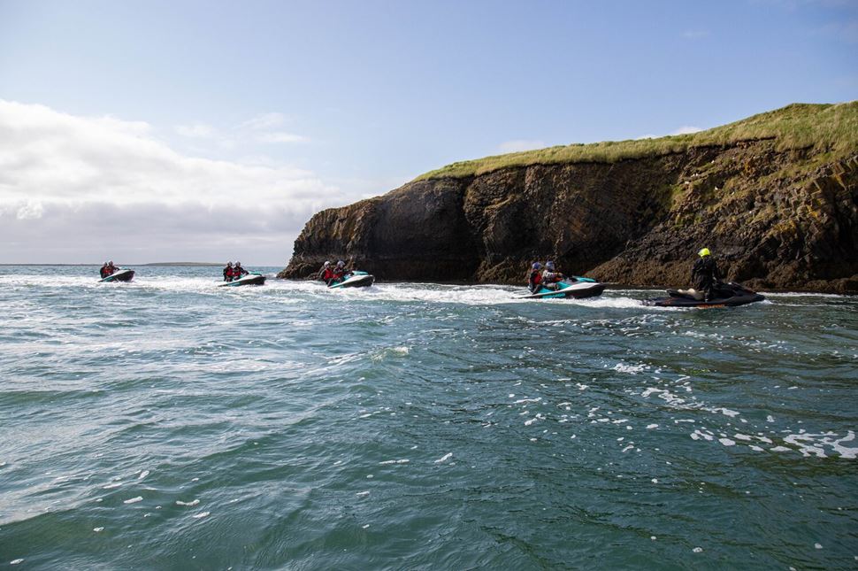Sea Cliffs Jet Ski Jet Ski tour group in distance in the sea in the foreground cliff edge