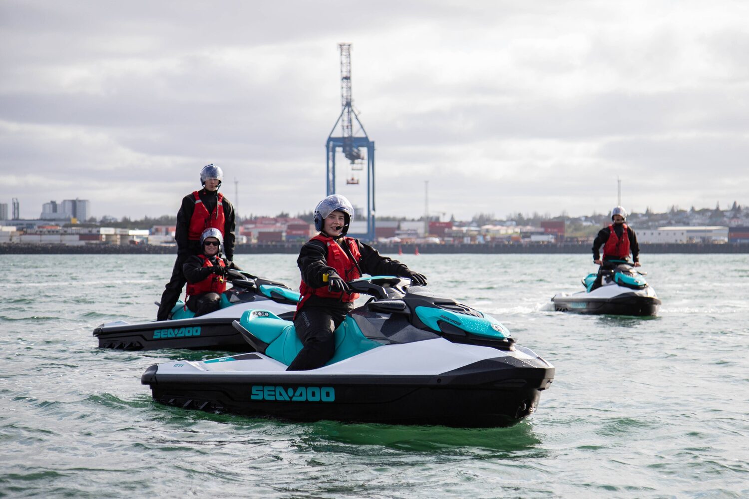 Group tour of three people on jet skis in the sea with jet ski gear